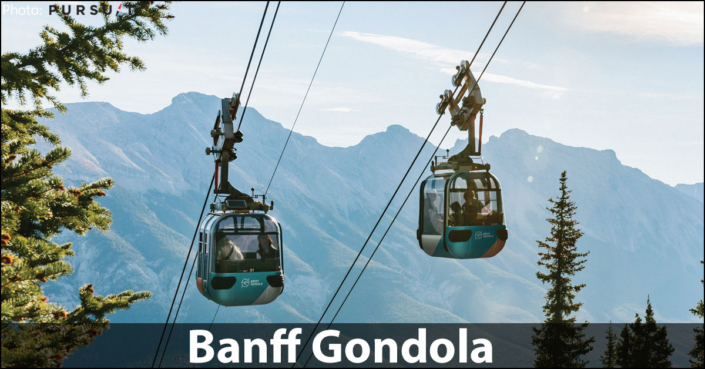 Four-passenger Banff Gondola cabin ascending Sulphur Mountain with the snow-capped Canadian Rocky Mountains and Bow Valley in the background.